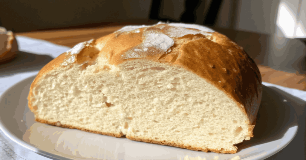 Rustic Basque sheepherder bread with a golden crust, freshly baked in a Dutch oven, showcasing traditional artisan bread.