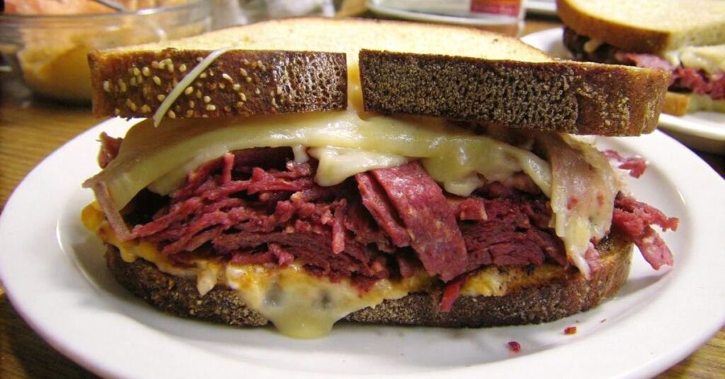 A classic Reuben sandwich recipe featuring toasted rye bread, piled high with tender corned beef, melted Swiss cheese, tangy sauerkraut, and creamy Russian dressing.