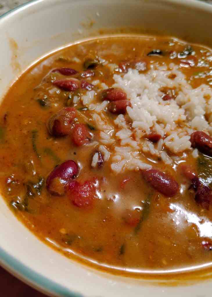 Close-up of red beans and rice with sausage slices and creamy beans