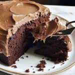Homemade chocolate cake recipe cooling in round metal pan