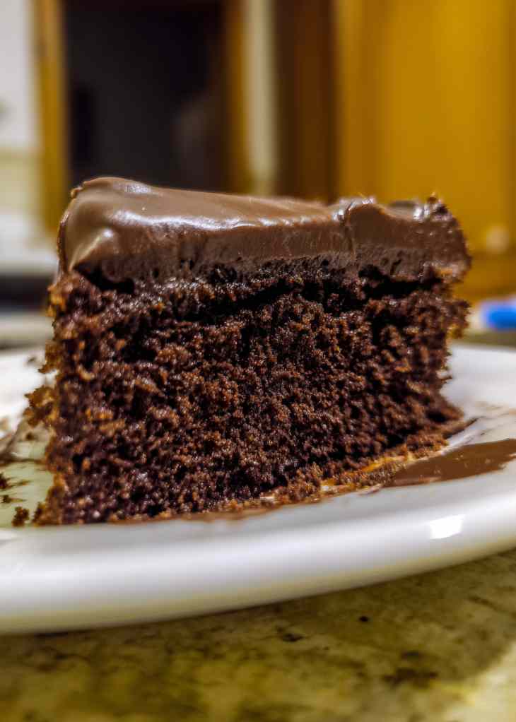 Chocolate cake recipe batter in mixing bowl with spoon