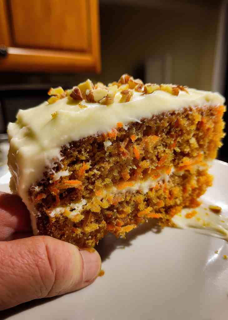 Homemade carrot cake with cream cheese frosting in round pan
