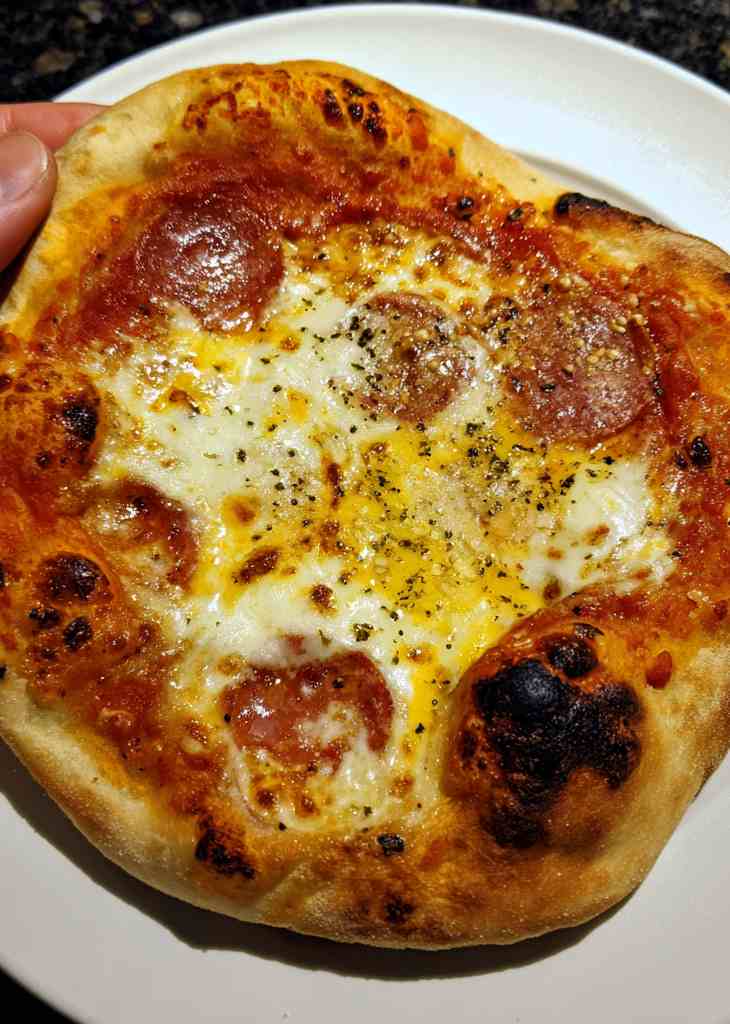 Hands kneading homemade pizza dough easy recipe on kitchen counter