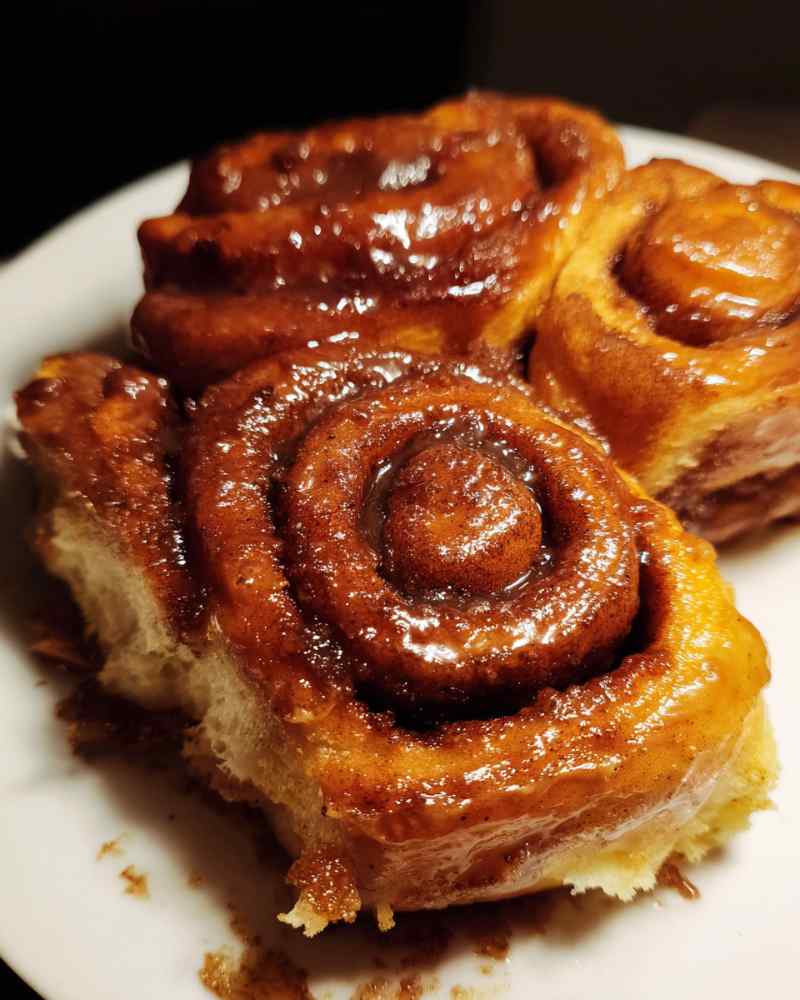 Pulled apart chai cinnamon roll showing soft layers and filling
