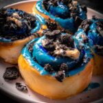 Cookie Monster Cinnamon Rolls with blue frosting in baking pan