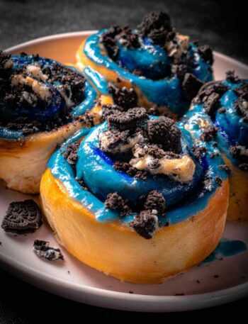 Cookie Monster Cinnamon Rolls with blue frosting in baking pan