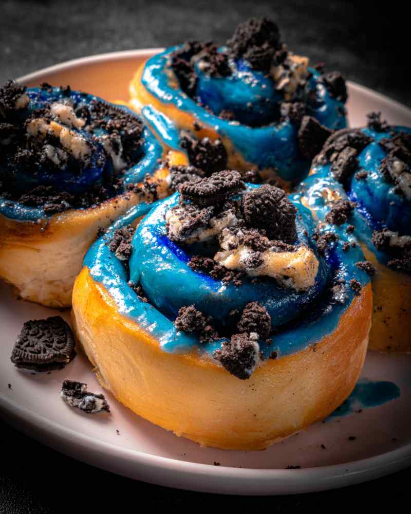 Cookie Monster Cinnamon Rolls with blue frosting in baking pan
