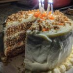 Homemade carrot cake birthday cake with candles and cream cheese frosting