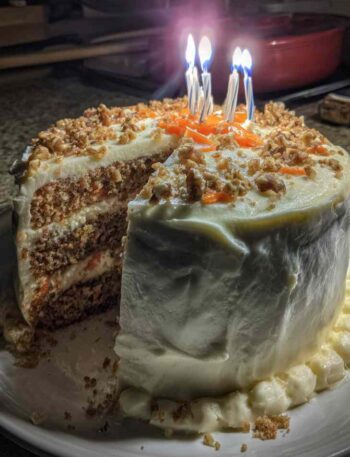 Homemade carrot cake birthday cake with candles and cream cheese frosting