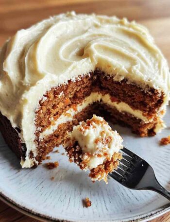 Homemade carrot cake with cream cheese frosting in round pan
