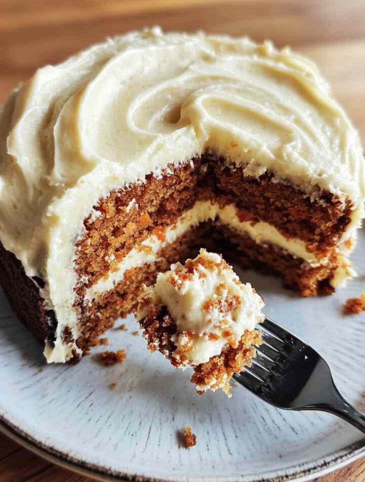 Homemade carrot cake with cream cheese frosting in round pan
