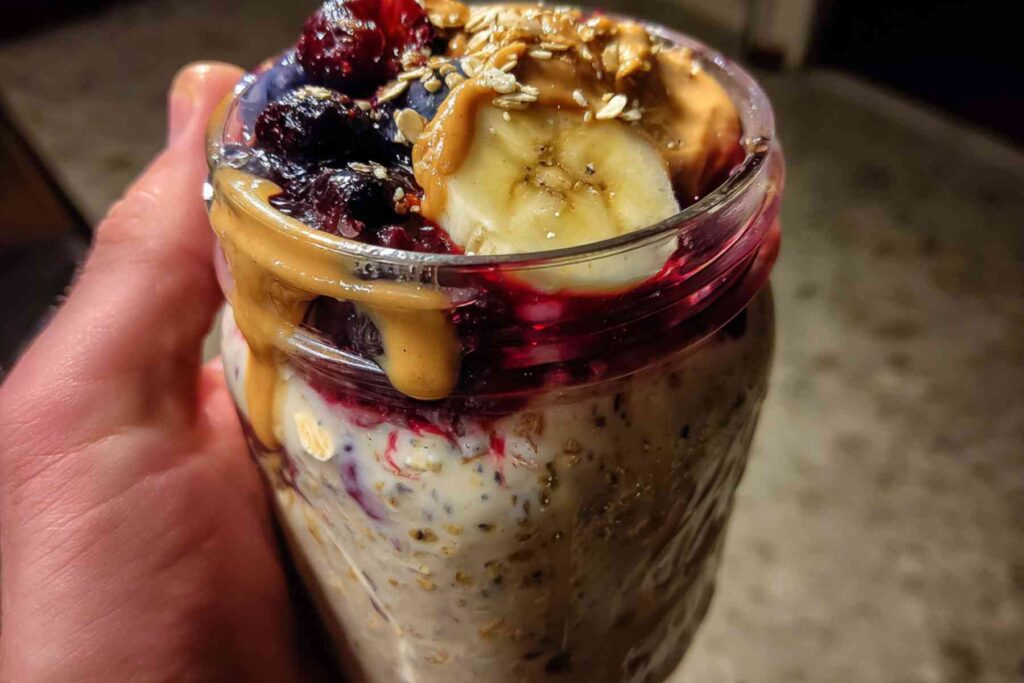 Overnight oats topped with bananas and berries in jar