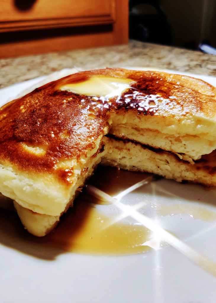Pancake batter spread in sheet pan before baking sheet pan pancakes