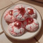 Strawberry Kiss Cookies with chocolate centers on a white plate