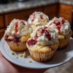 White chocolate raspberry cupcakes with uneven frosting on plate