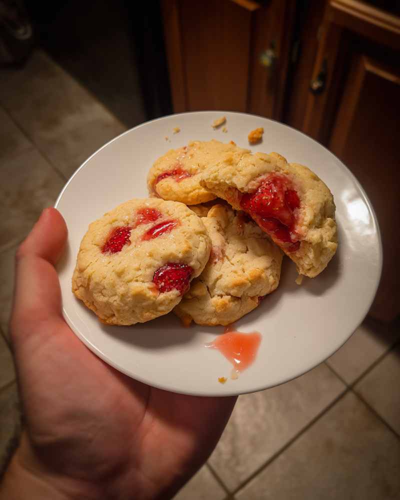 Unbaked strawberry shortcake cookie dough with chopped strawberries on tray